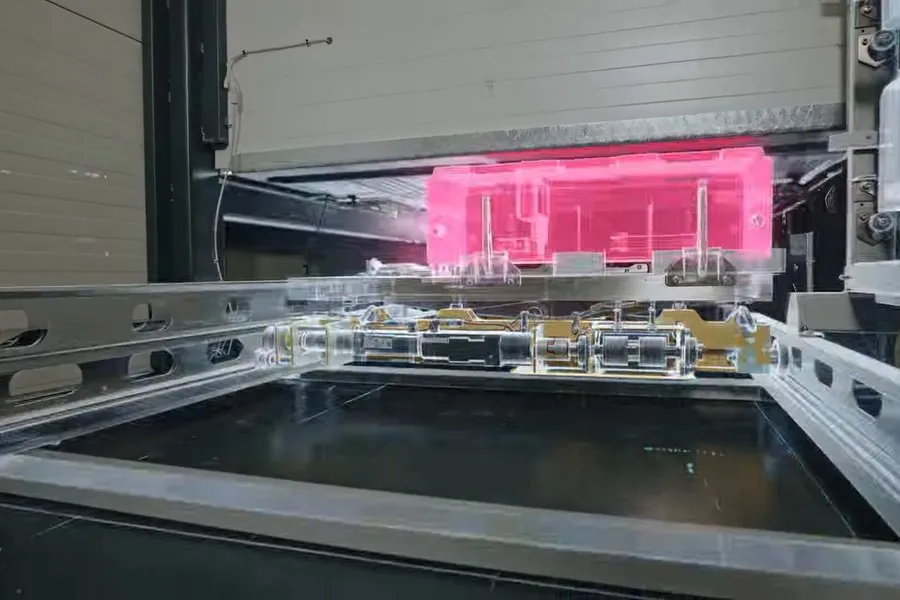 A battery pack lit pink inside the swap station, ready to be exchanged