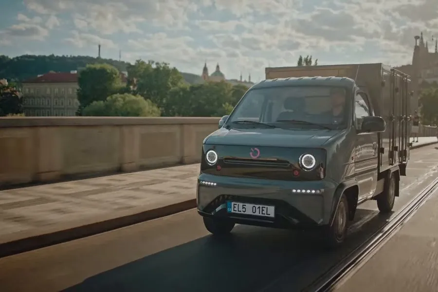 A Battswap vehicle on a bridge in Prague with the city behind it